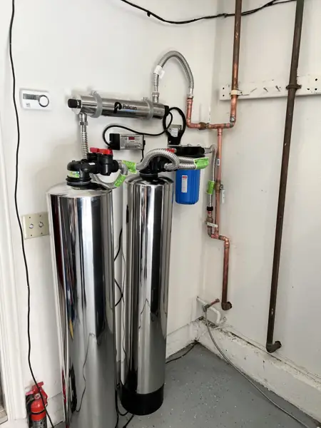 Pelican UV purifier with two stainless steel water treatment tanks and a sediment filter in a garage in Granada Hills
