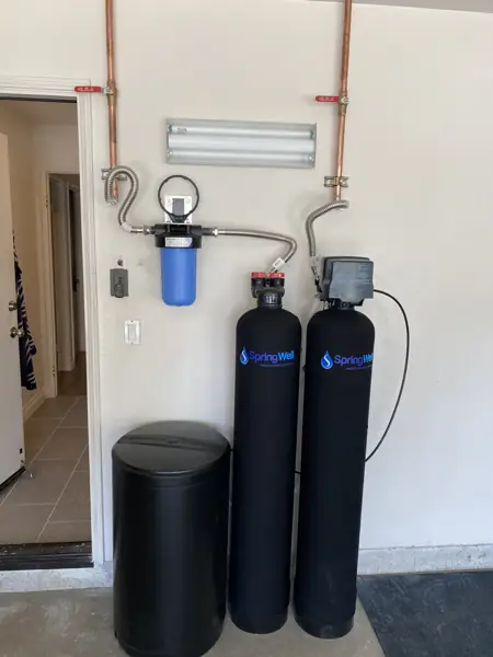 SpringWell water filter and softener tanks, brine tank and sediment filter installed in a garage in Valley Village