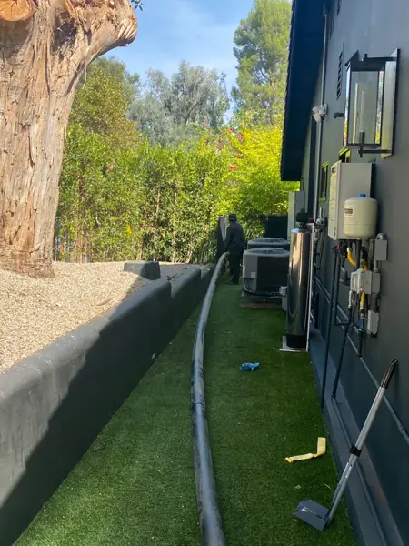New sewer pipe laid along a side yard before a trenchless sewer replacement in Woodland Hills