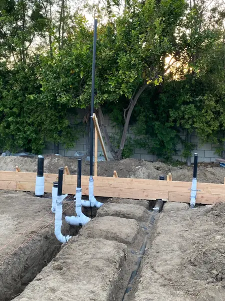 Underground drain lines and wrapped stub-ups in trenches for new construction in North Hills