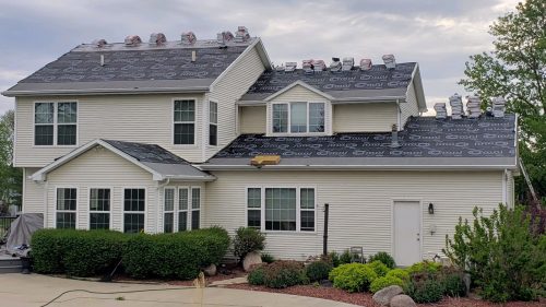 A house with many windows and a roof that has been replaced.