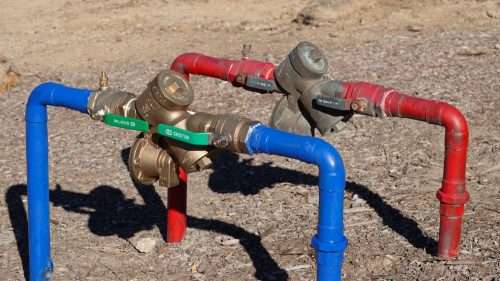 A couple of pipes that are connected to some water valves.